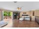 Open living room with wood floors, balcony access, and a wet bar for entertaining at 2501 Trentwood Blvd, Belle Isle, FL 32812
