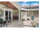 Covered outdoor kitchen with tiled backsplash, cooking area, and a nearby pool at 2501 Trentwood Blvd, Belle Isle, FL 32812