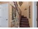 Wooden staircase with decorative mirror and sconces at 2501 Trentwood Blvd, Belle Isle, FL 32812