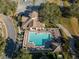 Aerial shot of community pool with lounge chairs, umbrellas, gazebo, and surrounding green landscape near parking at 25519 Hawks Run Ln, Sorrento, FL 32776