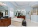 Luxurious bathroom featuring a soaking tub, dual vanities, and ample storage at 25519 Hawks Run Ln, Sorrento, FL 32776
