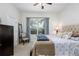 Comfortable bedroom with a ceiling fan, window with curtains, and an inviting bed for relaxation at 25519 Hawks Run Ln, Sorrento, FL 32776