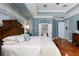 Spacious primary bedroom featuring tray ceilings, an accent wall, and hardwood flooring at 25519 Hawks Run Ln, Sorrento, FL 32776