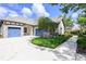 Well-manicured front yard and driveway leading up to a 3-car garage of this beautiful home at 25519 Hawks Run Ln, Sorrento, FL 32776