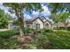 Beautiful single-Gathering home with lush front lawn, stone accents, a tile roof, and an attached garage at 25519 Hawks Run Ln, Sorrento, FL 32776
