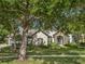 Stately home showcasing stone accents, arched entryway, mature landscaping, and a charming curb appeal at 25519 Hawks Run Ln, Sorrento, FL 32776