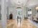 Stunning foyer with travertine flooring, large windows with blue curtains, and a decorative table at 25519 Hawks Run Ln, Sorrento, FL 32776