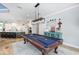 Open concept game room with pool table, view of the kitchen, and adjacent decorative elements at 25519 Hawks Run Ln, Sorrento, FL 32776