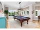 Bright game room featuring a pool table, tiled floor, and large windows overlooking the landscape at 25519 Hawks Run Ln, Sorrento, FL 32776