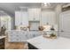 Elegant kitchen showcasing white cabinets, granite countertops, and modern finishes at 25519 Hawks Run Ln, Sorrento, FL 32776