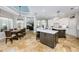 Open kitchen area with modern cabinets, dining area, and view to the living room at 25519 Hawks Run Ln, Sorrento, FL 32776