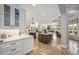 Expansive kitchen with double islands, white cabinets, and stainless steel appliances at 25519 Hawks Run Ln, Sorrento, FL 32776