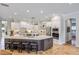 Spacious kitchen featuring an oversized island, white cabinets and stone floors at 25519 Hawks Run Ln, Sorrento, FL 32776