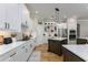Well-appointed kitchen with white cabinets, dark island, and modern appliances at 25519 Hawks Run Ln, Sorrento, FL 32776