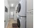 Bright laundry room with stacked washer/dryer, built-in storage and convenient access to the home's exterior at 25519 Hawks Run Ln, Sorrento, FL 32776