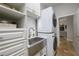 Well-equipped laundry room featuring a stainless steel farmhouse sink, modern washer/dryer, and custom cabinetry at 25519 Hawks Run Ln, Sorrento, FL 32776