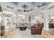 Bright living room with an open layout, coffered ceilings, and seamless flow to the kitchen at 25519 Hawks Run Ln, Sorrento, FL 32776