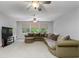 Expansive living room with neutral carpet, generous seating, and bright natural light at 25519 Hawks Run Ln, Sorrento, FL 32776