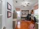 Spacious office with hardwood floors, neutral walls, multiple windows, and built-in shelving at 25519 Hawks Run Ln, Sorrento, FL 32776