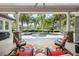 Relaxing covered patio with a view of the pool and lush landscaping at 25519 Hawks Run Ln, Sorrento, FL 32776