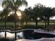Stunning pool area with serene views of the lush green golf course, perfect for relaxation and leisure at 25519 Hawks Run Ln, Sorrento, FL 32776