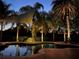 Inviting pool area with decorative lighting, lush landscaping, and serene ambiance for relaxation at 25519 Hawks Run Ln, Sorrento, FL 32776