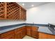 Close-up of a well-equipped wet bar with dark countertops and rich wood cabinetry at 25519 Hawks Run Ln, Sorrento, FL 32776