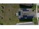 Aerial view showcases the home's layout, solar panels, outdoor furniture, and green surroundings at 2825 Muller Oak Loop, Ocoee, FL 34761