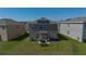 The backyard features a well-maintained lawn, solar panels, a patio set, and a picnic table at 2825 Muller Oak Loop, Ocoee, FL 34761