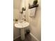 Cozy powder room with a pedestal sink and decorative accents at 2825 Muller Oak Loop, Ocoee, FL 34761