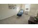 Bright bedroom area with plush lounge chair, side table with flowers, and natural light at 2825 Muller Oak Loop, Ocoee, FL 34761