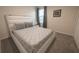 Bright bedroom features a large bed with modern grey and white geometric patterned bedding at 2825 Muller Oak Loop, Ocoee, FL 34761
