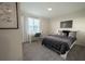 Bedroom with gray and black bedding, white modern desk, chair and a window at 2825 Muller Oak Loop, Ocoee, FL 34761