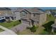 Stunning two-story house with a well-kept lawn and brick driveway at 2825 Muller Oak Loop, Ocoee, FL 34761