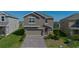 Charming two-story home featuring a well-manicured lawn and a brick driveway at 2825 Muller Oak Loop, Ocoee, FL 34761