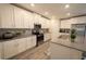 Modern kitchen featuring quartz countertops, stainless steel appliances, and white cabinets at 2825 Muller Oak Loop, Ocoee, FL 34761