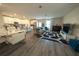 Open-concept living room with modern decor and hardwood floors at 2825 Muller Oak Loop, Ocoee, FL 34761
