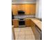 This kitchen is equipped with stainless steel appliances and light wood cabinets at 3181 Capri Isle Way, Orlando, FL 32835