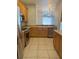 A kitchen features stainless steel appliances, light wood cabinets, and ample counter space at 3181 Capri Isle Way, Orlando, FL 32835
