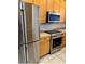 This kitchen features stainless steel appliances, including a refrigerator, oven, and microwave at 3181 Capri Isle Way, Orlando, FL 32835