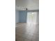 Bright living room featuring tile flooring and a sliding glass door at 3181 Capri Isle Way, Orlando, FL 32835