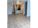 Open-concept living space with tile floors, stylish lighting, and access to the kitchen at 3181 Capri Isle Way, Orlando, FL 32835