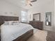 Comfortable bedroom with a ceiling fan, large window, and neutral decor at 3505 Rhapsody St, St Cloud, FL 34772
