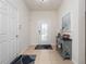 Bright foyer with tile flooring, decorative table, and a view of the front door at 3505 Rhapsody St, St Cloud, FL 34772
