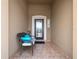 Cozy covered front porch with a comfortable chair, decorative accents, and tiled flooring at 3505 Rhapsody St, St Cloud, FL 34772