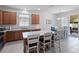 Open kitchen with counter seating, stainless appliances, and views of the dining area at 3505 Rhapsody St, St Cloud, FL 34772