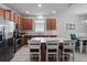 Bright kitchen features an island with seating and stainless steel appliances at 3505 Rhapsody St, St Cloud, FL 34772