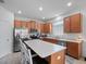Open kitchen with a large island, tile floors and stainless steel appliances at 3505 Rhapsody St, St Cloud, FL 34772