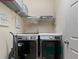 Efficient laundry room with modern, front-load washer and dryer, wire rack shelving, and painted walls at 3505 Rhapsody St, St Cloud, FL 34772