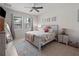 Inviting main bedroom features a ceiling fan and a large window at 3505 Rhapsody St, St Cloud, FL 34772